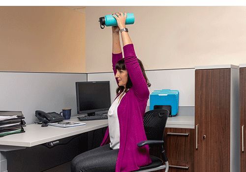 Woman performing Desk Exercise Tricep Press Arm Weightlifting