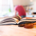 Closeup of an open cookbook sitting on a kitchen counter