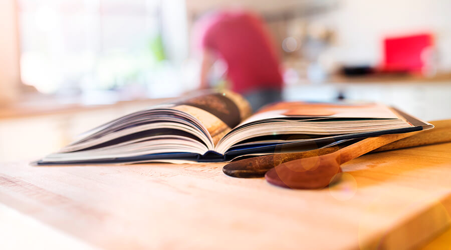 Open cookbook on kitchen counter Open cookbook on kitchen counter