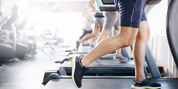 Gym with many people running on treadmills