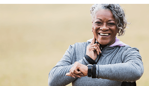 Woman checking her pulse with her finger and a wrist watch Woman checking her pulse with her finger and a wrist watch