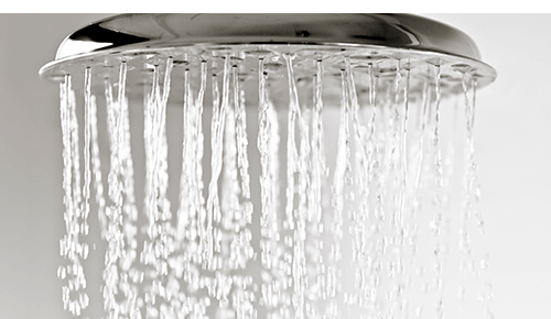 Closeup of water flowing from shower head