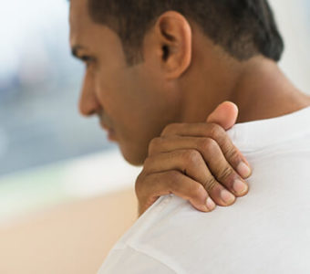 Man holding shoulder in pain