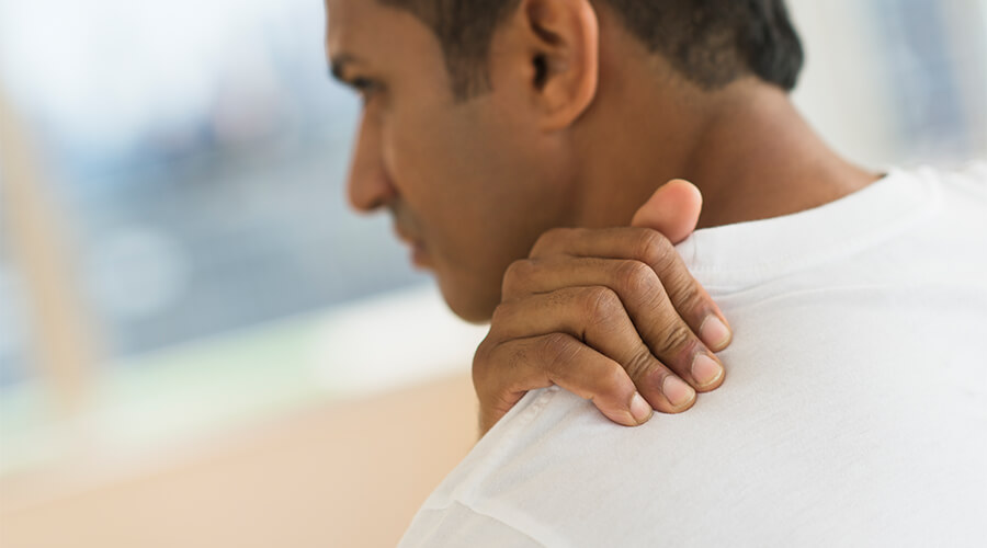 Man holding shoulder in pain
