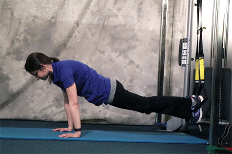 Person performing Pike to push-up to knee tuck TRX Exercise