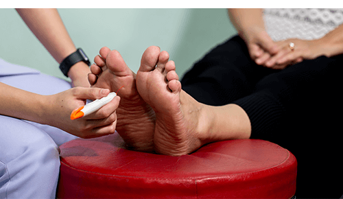 Doctor examining the bottom of a person's foot