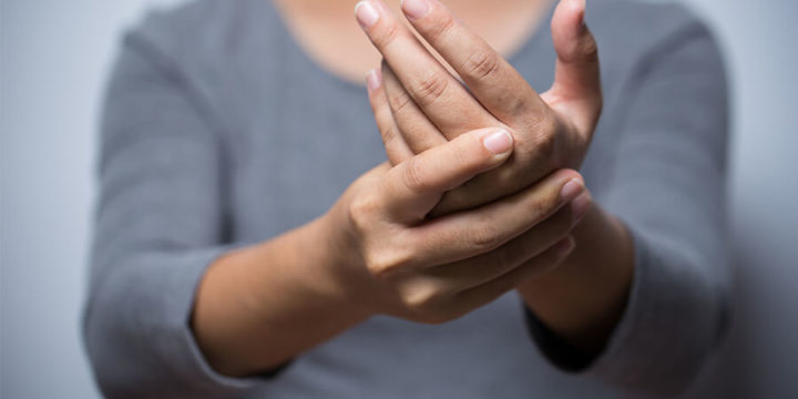 Closeup of someone holding their hand in their other hand