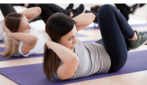 Group of people working out performing core exercise