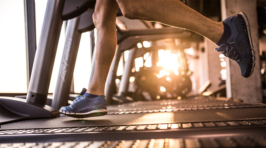 Closeup of person running on a treadmill Closeup of person running on a treadmill