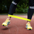 Person performing leg workout using exercise bands
