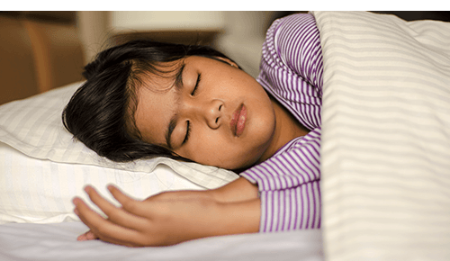 Child Sleeping in Bed