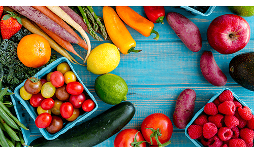 Colorful fruits and vegetables on a blue background