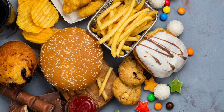 Variety of fried and fast foods on gray surface