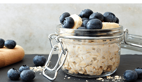 Mason Jar Overnight Oats with blueberries and banana slices on top