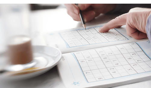 Person doing Sudoku puzzle