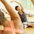 Group doing yoga and stretching in gym studio