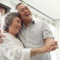 Older couple dancing and holding hands