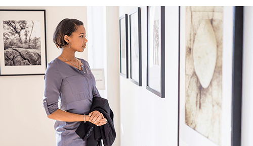 Woman looking at art in museum