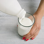 Pouring glass of milk