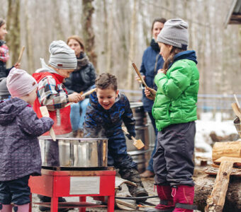 Children tasting maple syrup