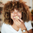 Woman smiling while eating food