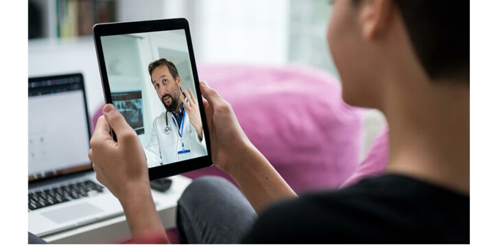 Person talking to doctor during virtual visit on tablet