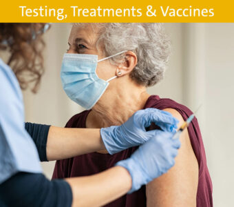 Older woman receiving vaccine with face mask on