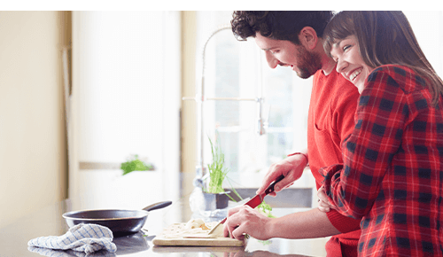 Couple cooking together in kitchen