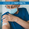 Person holding arm with a band-aid on it after receiving COVID-19 vaccination