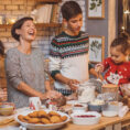 Family baking holiday treats in kitchen