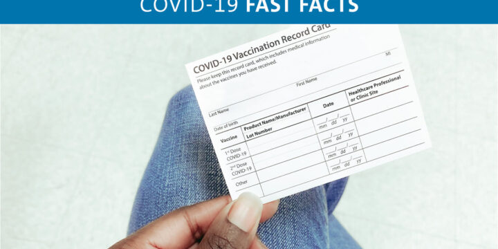 Person holding vaccination record card