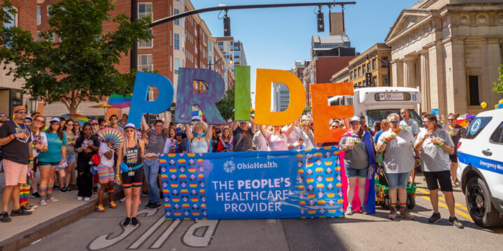 OhioHealth associates at Columbus Pride Parade holding up a rainbow 
