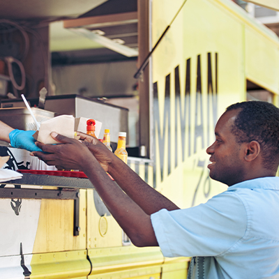 Man grabbing food ordered at food truck