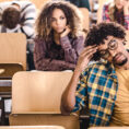 Group of young adults looking stressed in classroom