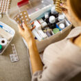 Person putting together a first aid kit