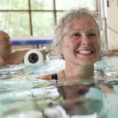 older person exercising in pool