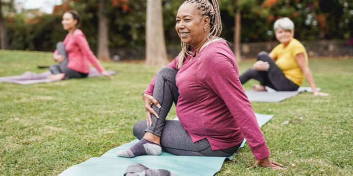 Group of people doing yoga outdoors