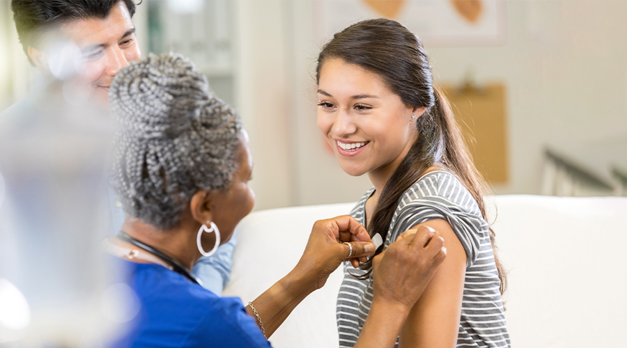 Young girl getting a vaccination at doctor