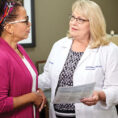 Cancer navigators speaking with patient
