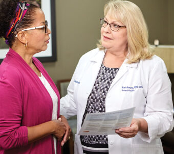 Cancer navigators speaking with patient