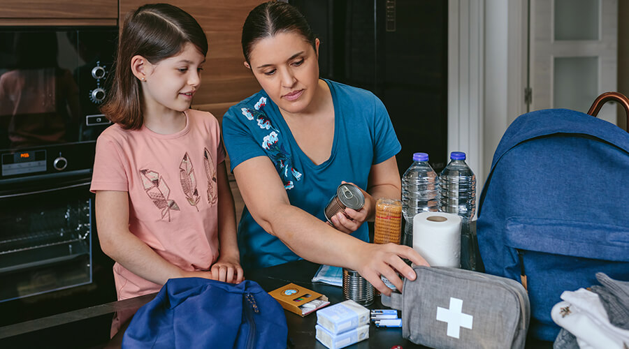 Mom and daughter setting up an emergency kit for home