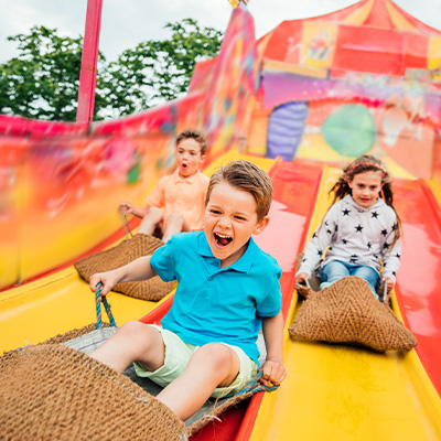 Group of kids going down slides