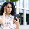 Women getting stressed after reading news on her phone