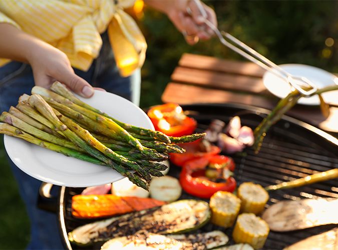 Close up of person grilling vegetables