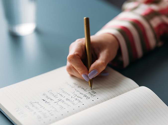 Close up of hand making to do list