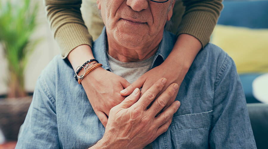 man being comforted by family member