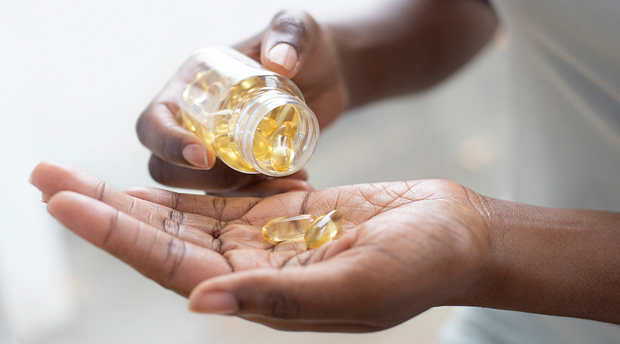 hand pouring vitamins