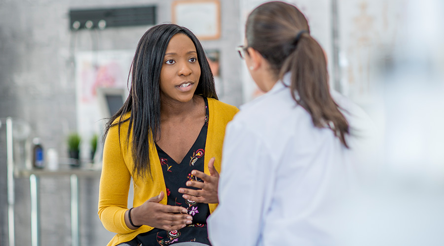 Woman asking doctor questions