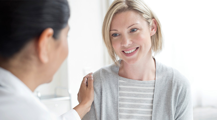 Doctor comforting female paitent