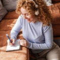 Woman journaling in her living room